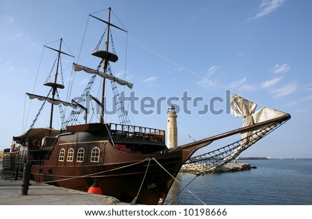 A mock pirate ship, used for tourist pleasure trips from Rethymnon, Crete, a city that oncefeared the Mediterranean corsairs. The cannon sunk in the quay as a bollard (bottom left) is genuine.