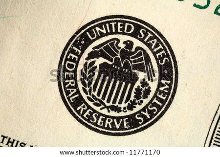 Macro of the Federal Reserve seal printed on a US banknote.