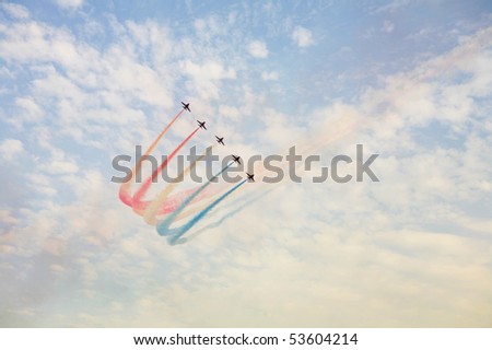 An aerobatic display team paints the sky red, white and blue during a performance