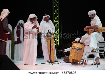DOHA, QATAR - JANUARY 8: A Qatari folk troupe performs at a cultural event in Doha, Qatar, January 8, 2011, marking the Asian Cup football being hosted in the Gulf emirate.