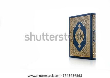 Islamic concept - The Holy Al Quran with written Arabic calligraphy meaning of Al Quran, Arabic word translation : The Holy Al Quran (holy book of Muslim), on white background, with copy space.