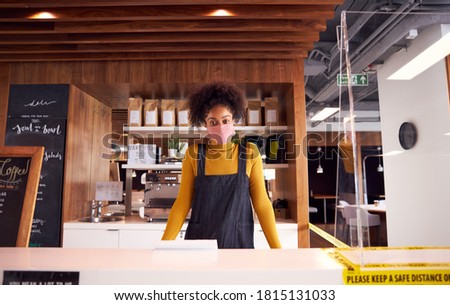 Portrait Of Female Business Owner Of Coffee Shop In Mask Behind Counter During Health Pandemic Photo stock © 