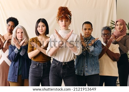 Young white woman gesturing Break The Bias in support of International Women's Day with female friends Foto stock © 
