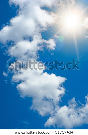 Sun rays against a blue summer sky. Vertical orientation.
