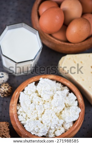 still life with dairy products as milk, cheese cottage cheese eggs and bread