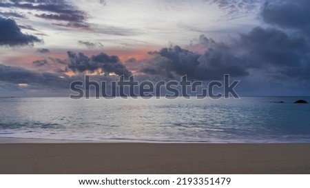 Beautiful sunset on a tropical island. In the sky, illuminated with scarlet, dark blue clouds. Calm turquoise ocean. Foam of waves on the sand. Seychelles. Mahe. Beau Vallon beach Photo stock © 