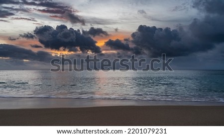 Picturesque sunset over the Indian Ocean. Blue clouds in the sky, highlighted in orange. Reflection on calm water. Foam of waves on the sand of the beach. Seychelles. Mahe. Beau Vallon Photo stock © 
