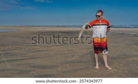 Similar – Image, Stock Photo Man cycling on sandy beach hill