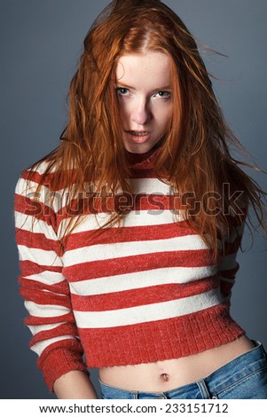 redhead young sweet girl in the studio wearing a sweater, tenderness, femininity, sexy
