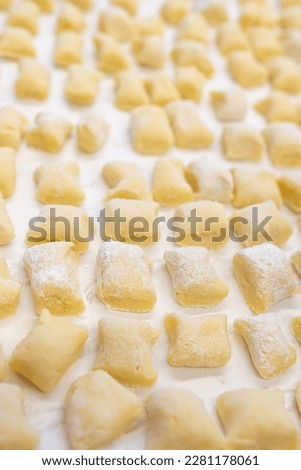 Similar – Image, Stock Photo Homemade gnocchi making preparation. Potatoes dough on dark rustic kitchen table with cutting board and healthy ingredients. Tasty home cuisine. Top view. Still life