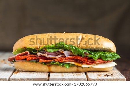 Salami sandwich on baguette with linen backdrop