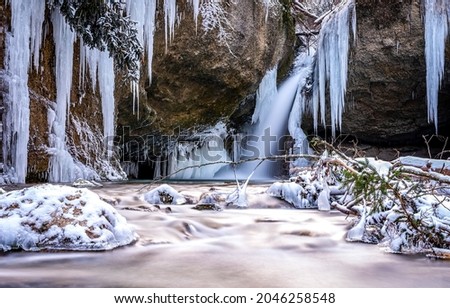 Frozen waterfall in winter scene. Frozen waterfall icilces. Icicles of frozen waterfall