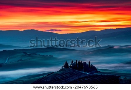 Sunset with fog over the mountain hills. Mountain sunset landscape. Sunset in mountains. Mountain sunset fog