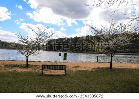 Similar – Image, Stock Photo Rippling lake surrounded by rocky mountains against cloudy blue sky