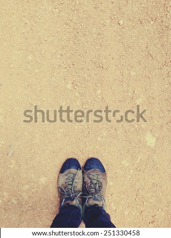 Treking shoes on brown sand, vintage