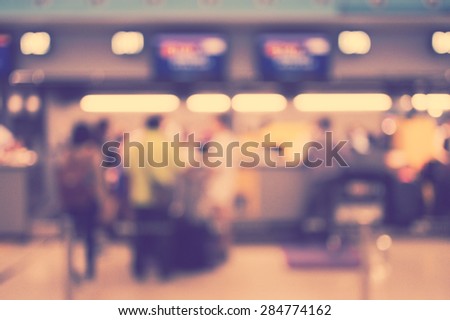 Blurred image of people in queuing at airport checking in counter, toned photo, vintage filter