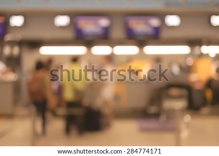 Blurred image of people in queuing at airport checking in counter
