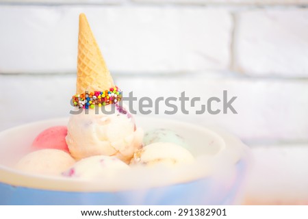 Birthday Ice Cream Set with Colorful Sprinkles Cone on Top and Dry Ice on the Bottom, Selective Focus, Blur Brick Background, Wallpaper. Birthday Celebration Concept. Sweet Pastel Theme.