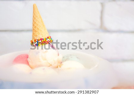 Birthday Ice Cream Set with Colorful Sprinkles Cone on Top and Dry Ice on the Bottom, Selective Focus, Blur Brick Background, Wallpaper. Birthday Celebration Concept. [Original Collection]