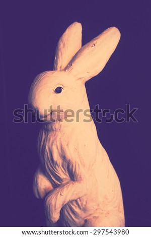 Sculpture of a Realistic White Rabbit as Interior Decoration, Selective Focus on the Eye, Isolated on Black Background, Toned Photo [Vintage Collection]