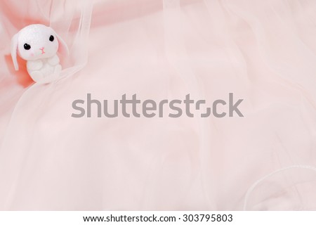 Cute Rabbit Plush Doll on the Pink Ballerina Tutu Skirt for Background, Wallpaper