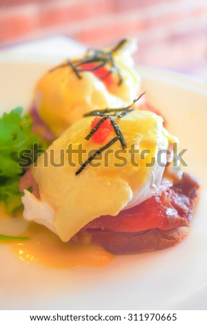 Soft Focus of delicious Eggs Benedict with Smoked Salmon, Hollandaise Sauce, and Chives on Toast.