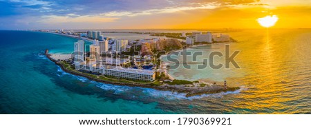 Aerial panoramic view of the northern peninsula of the Hotel Zone (Zona Hotelera) in Cancún, Mexico at sunset