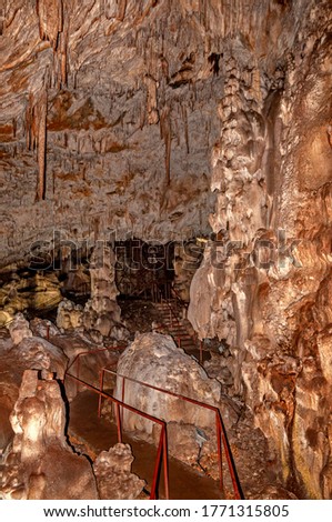 Little known cave Dobrostanski biser - Bulgaria. Illuminated rock cave formations - stalactites, stalagmites and stalactons Imagine de stoc © 