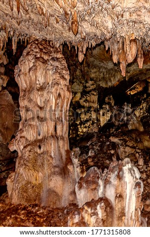 Little known cave Dobrostanski biser - Bulgaria. Illuminated rock cave formations - stalactites, stalagmites and stalactons Imagine de stoc © 