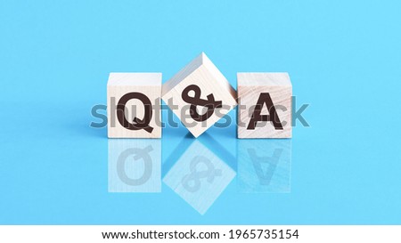 the text q and a written on the cubes in black letters, the cubes are located on a blue glass surface. Concept word forming with cube on background - questions and answers Stock foto © 