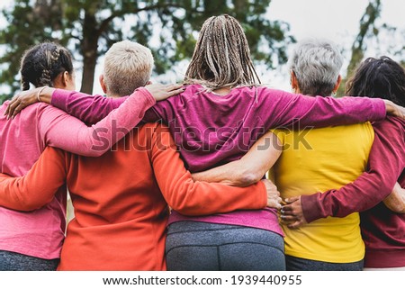 Multi generational women hugging each other outdoor - Multiracial people and teamwork concept