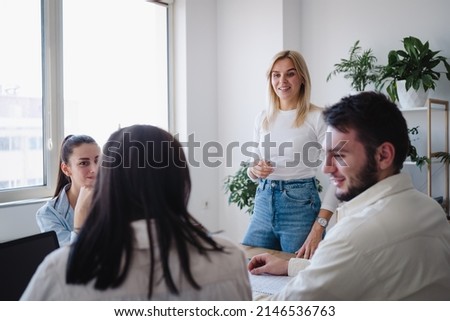 Ambitious smart female employee speaking at the meeting and share creative idea opinion at group briefing while coworkers looking and listening to colleague  Stock fotó © 