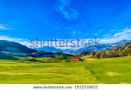 Summer mountain green field blue sky landscape. Mountain green valley meadow landscape. Green meadow in mountain valley. Summer green meadow in mountain valley