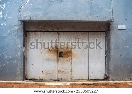 Similar – Image, Stock Photo An old weathered garage door. The blue and white paint is flaking off artfully.