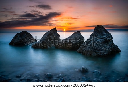 Sea rocks at sunset landscape. Sunset sea rocks. Sunset over the sea. Sunset sea landscape