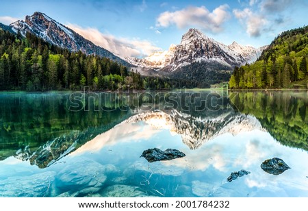 Panorama of a mountain lake. Mountain lake landscape. Lake in mountains. Mountain lake view