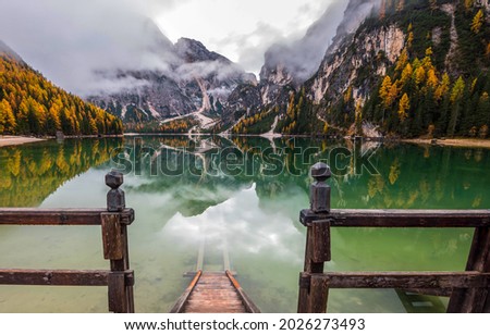 Descent into the water of a mountain lake. Mountain lake water. Mountain lake view. Autumn water in mountains