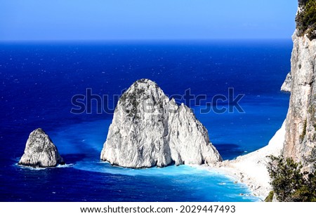 Coastal rock on the seashore. Rock island in blue sea. Sea rock. Beautiful coastal landscape