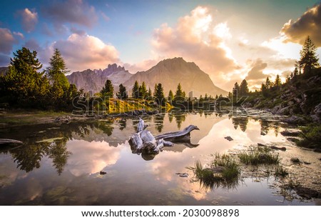 Morning sunrise in the mountains. Mountain lake water at dawn. Sunrise in mountains