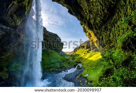 Waterfall in the green mountains. Mountain waterfall view. Waterfall in mountains. Waterfall landscape