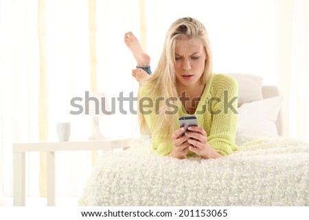 young girl is sitting on the bed