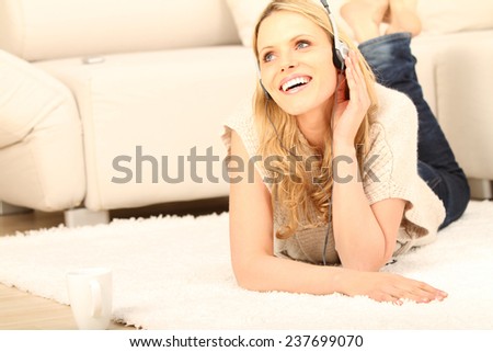 woman lying on the floor and listening to music