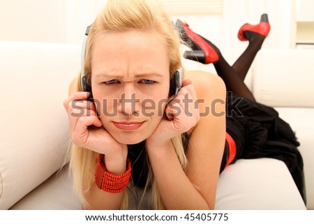 young female annoyed by some strange sound over her headphones
