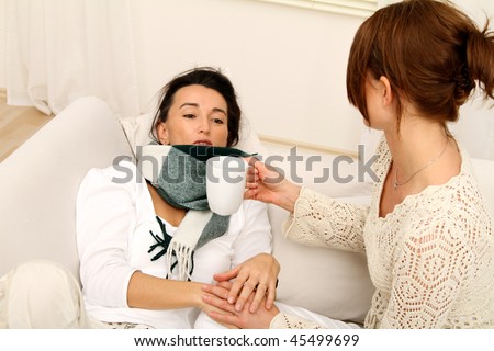 there are two woman on the couch and one of them is ill