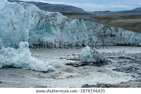 melting glaciers in Greenland. Summer time in Greenland. Warming climate. Travel to Kangerlussuaq Greenland. Glacier moving over the stones. streams of water rush through the tundra to the ocean. 
