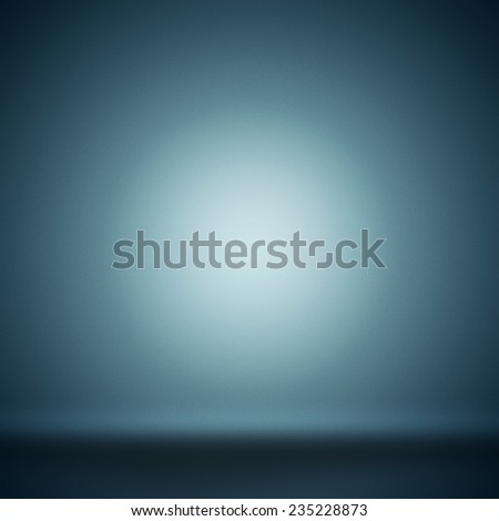 Abstract blank background toned blue with grain and circle spotlight.
