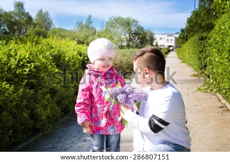 brother, sister gives flowers