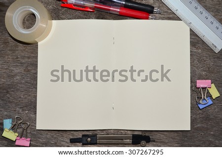 Open a blank white notebook, pen, clip, ruler, stick tape