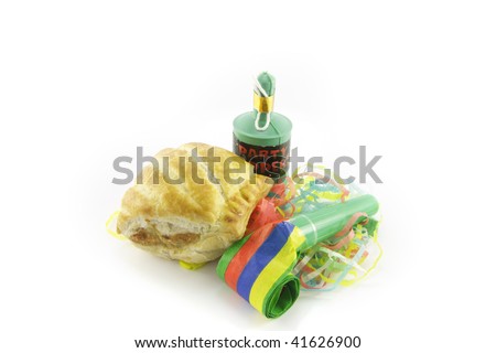 Small tasty sausage roll with party blower and party popper with streamers on a reflective white background