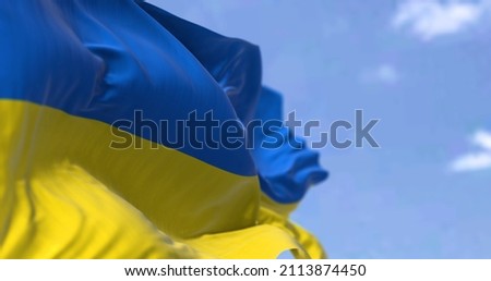 Detail of the national flag of Ukraine waving in the wind on a clear day. Democracy and politics. Eastern Europe country. Patriotism. Selective focus. Stock fotó © 